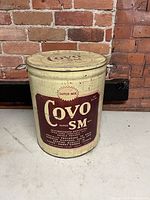 Front view of cylindrical Covo SM 50 lb tin with lid and handles