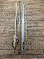 Four measuring sticks laid out side-by-side