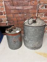 Both large and small galvanized CN cans side by side showing size difference and overall condition