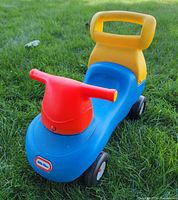 Full view of ride-on from front-right angle showing color scheme and design