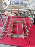 Two-tier wire basket unit with rails on red table