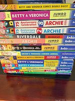 Stack of 12–14 Archie digest comics showing all spines