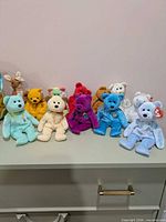 Group of twelve Ty Beanie Baby plush figures displayed on surface