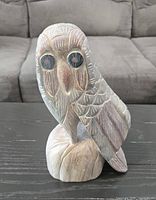 front view of wood owl figurine showing carved details and painted eyes