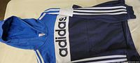 Front view showing adidas logo, stripes and color scheme