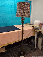 Full view of floor lamp with floral shade