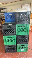 Stack of black and green crates with Nelson logo visible