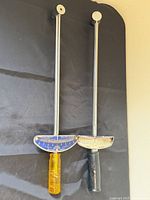 Both beam torque wrenches hanging side-by-side showing full length and handles