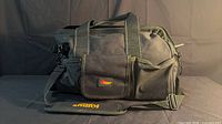 Front view of Kuny’s tool bag showing size, material, strap, pocket, logo