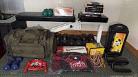 Overall view of bench, dumbbells, bags, accessories and books