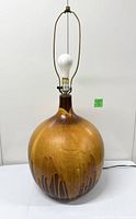 Front view of ceramic lamp with harp and bulb attached