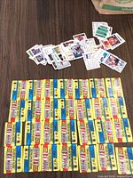 Table view showing grid of sealed yellow 1989-90 O-Pee-Chee hockey packs and pile of loose cards