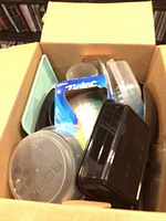 Box showing various plastic containers and possible pan