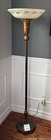 Full view of floor lamp standing in corner showing entire height and base
