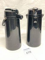 Front view of two black Techni-Brew airpot carafes