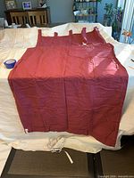 Solid burgundy tab-top panel unfolded on table