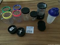 Full contents: blender base, cups, lids, blades, Tupperware shaker