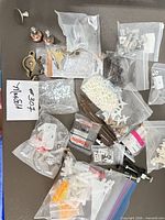 Top view showing entire assortment of hardware in bags on tray