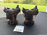 Front view of both plaster Western saddle candle holders