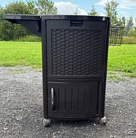 Front view of resin cooler on wheels with side tray folded, wire basket visible