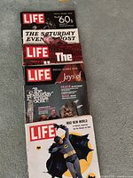 Stack top to bottom view showing six magazine covers