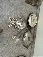 Group view of casseroles, bowl, utensils, trivet