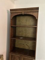 Front view of tall wooden shelving unit