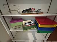 middle shelves showing storage boxes and letter trays