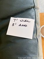 Close-up of leather surface with dimension note
