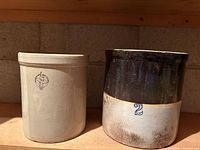 Both crocks side by side showing size, glaze difference and blue markings