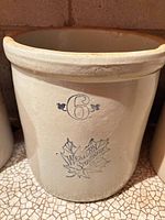 Front view showing blue 6 and maple leaf logo on crock exterior