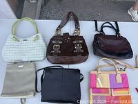 Top view of all six handbags displayed on table