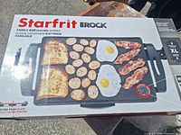 Front of unopened Starfrit The Rock electric griddle box showing product image and features