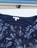 Label and fabric pattern on navy paisley Laura blouse
