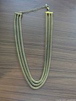 Full view of multi-strand gold-tone necklace