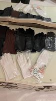 All gloves laid out on dresser with mirror showing quantity and colors