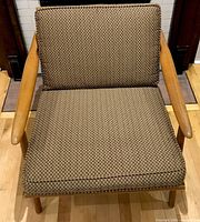 Front view of lounge chair showing cushions and arms