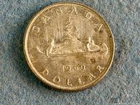 Reverse side showing Voyageur canoe, date and denomination