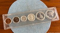 Front view of six-coin Centennial set in Whitman holder