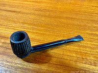 Left side view of pipe showing bowl texture and full stem length