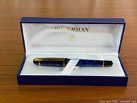 Pen resting in open Waterman box