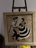 Front view of framed hair-on-hide patchwork mosaic showing dancers