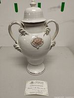 Front view of porcelain lidded urn