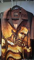 Full view of front of Bob Marley shirt on hanger