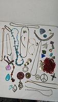 Top-down view of mixed jewelry pieces spread on table