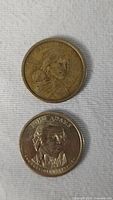 Obverse sides of Sacagawea and John Adams $1 coins