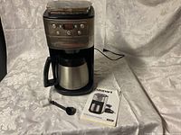 Coffee maker with carafe, power cord, scoop, filter and instruction booklet