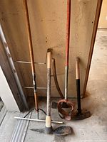 Group shot of all four yard tools leaning against wall