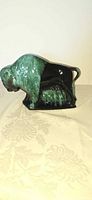 Left side view of Blue Mountain Pottery bison figurine displaying glaze and form