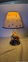 Lamp illuminated showing shade design and character base